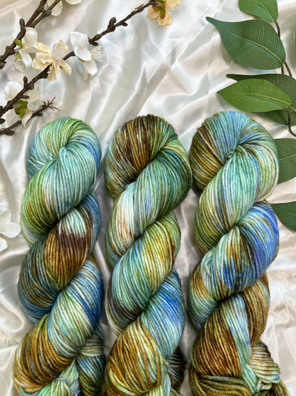 custom bright blue, green, cornflower blue, tan, brown variegated hand dyed yarn on superwash merino dk weight