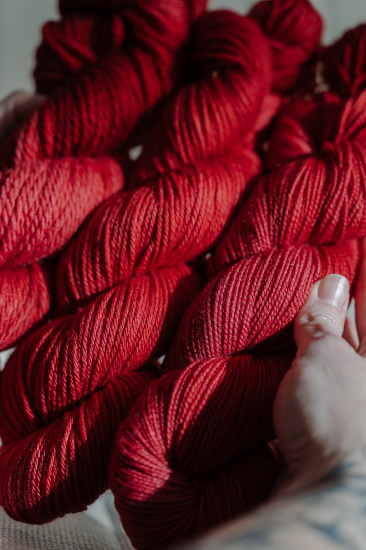 custom medium toned cherry red semisolid hand dyed yarn on nylon superwash sock yarn