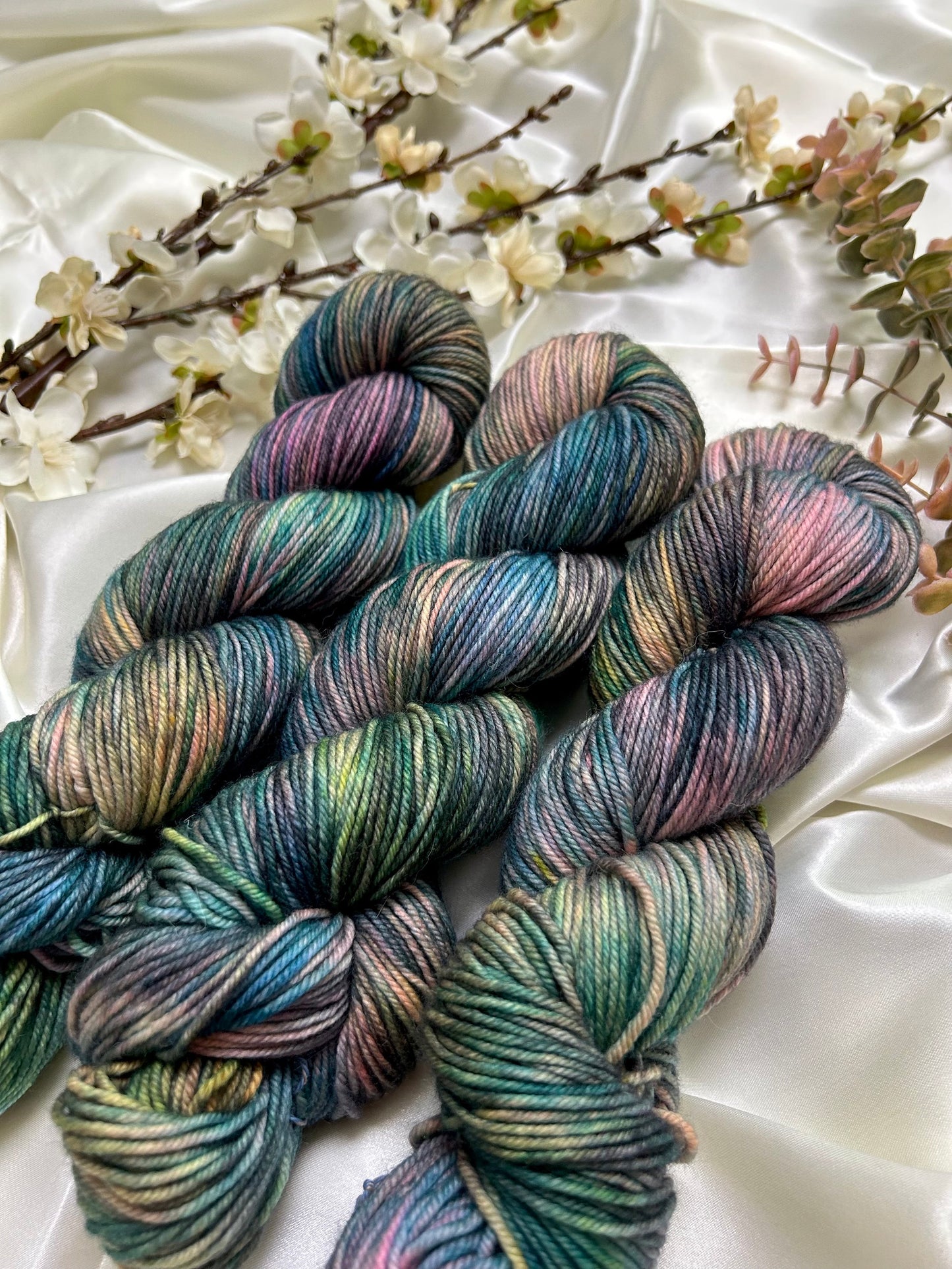 custom black, neon pink, teal, green blue variegated hand dyed yarn on nylon superwash merino dk weight