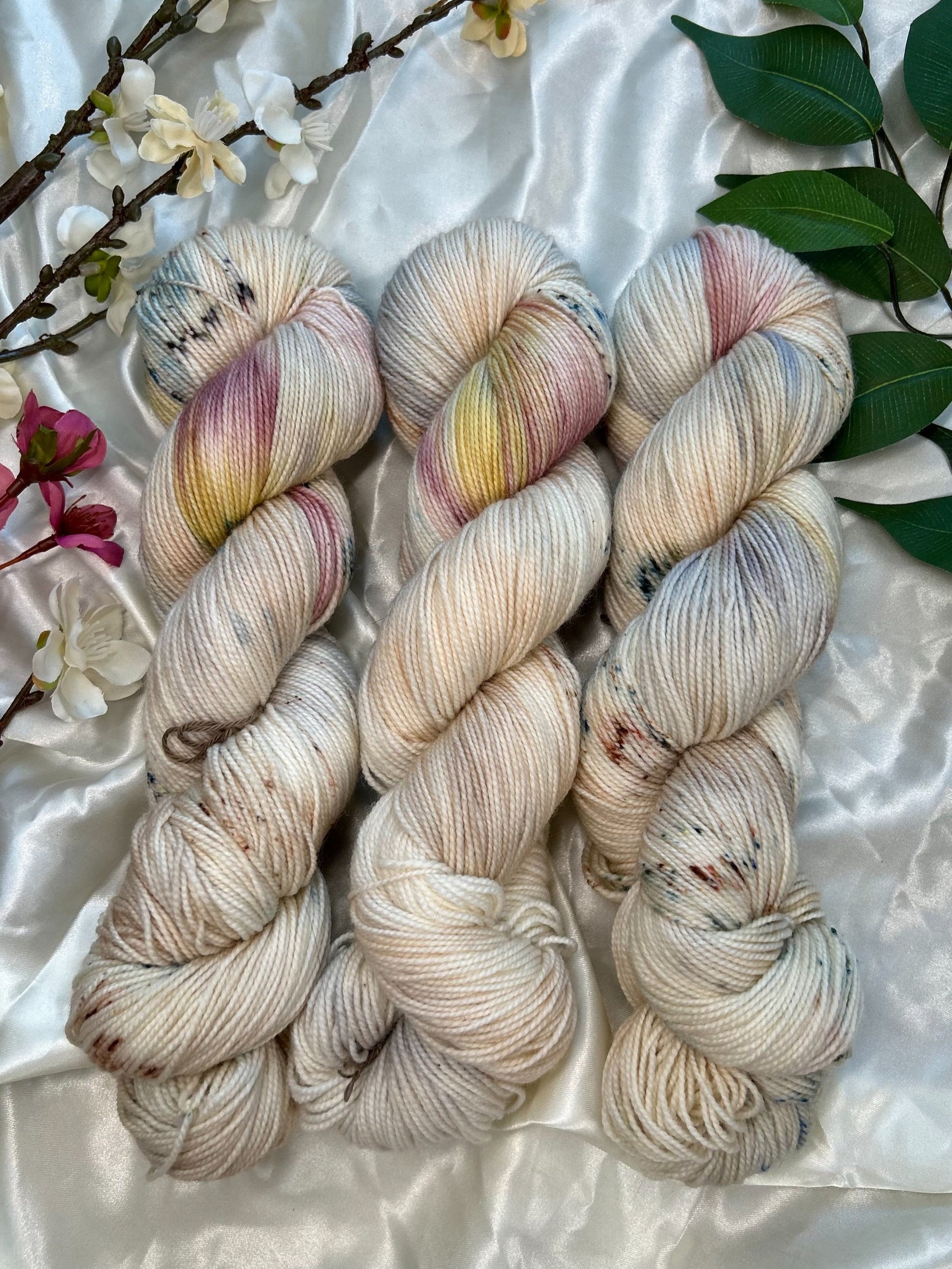 custom cream, tan, indigo, burgundy, gold variegated hand dyed yarn with tan speckles on nylon superwash sock weight