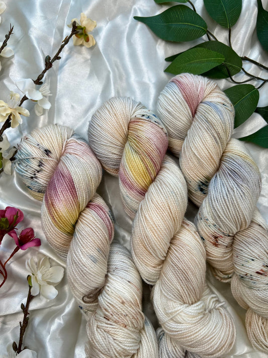 custom cream, tan, indigo, burgundy, gold variegated hand dyed yarn with tan speckles on nylon superwash sock weight