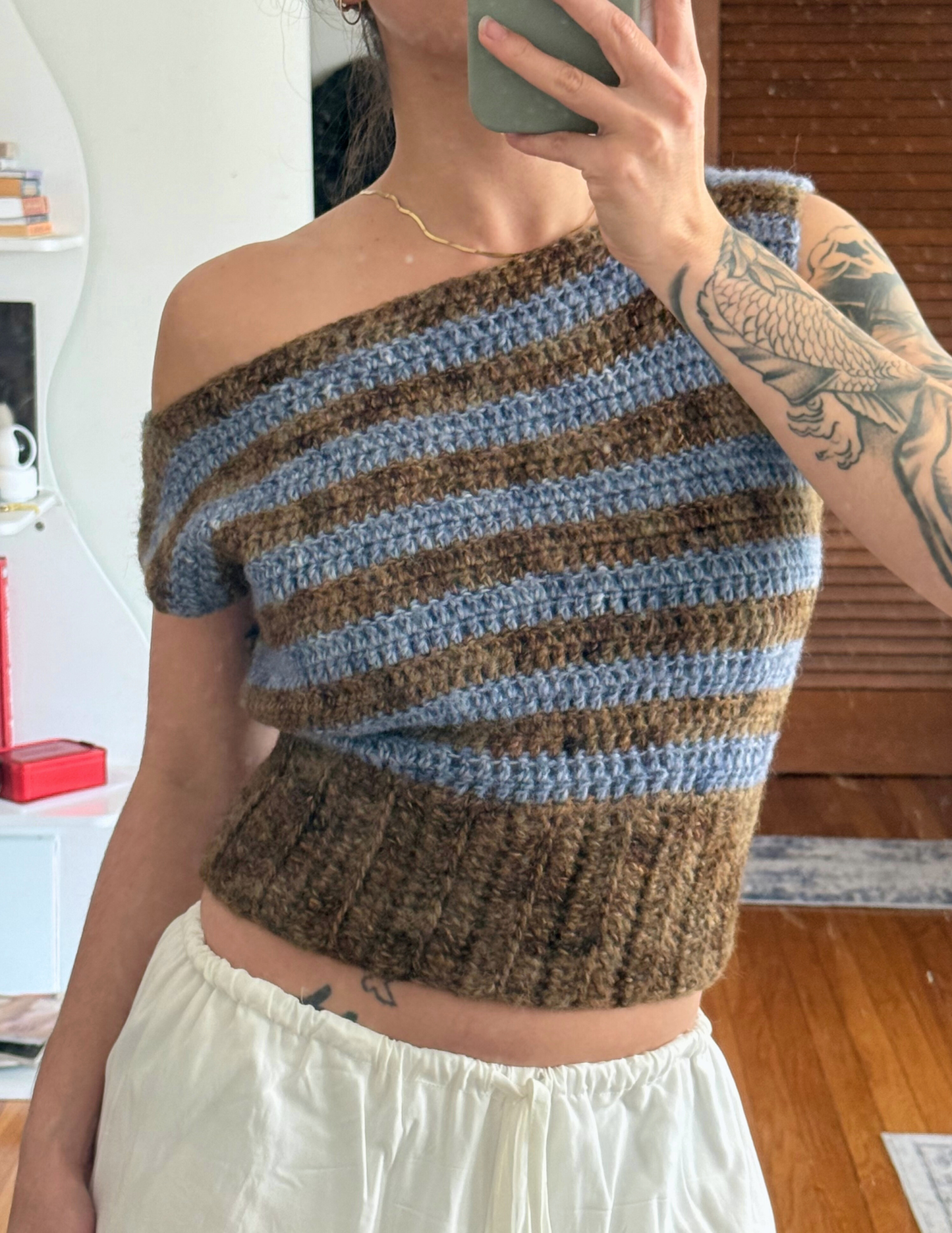 woman wearing striped short sleeve slouchy blouse crochet