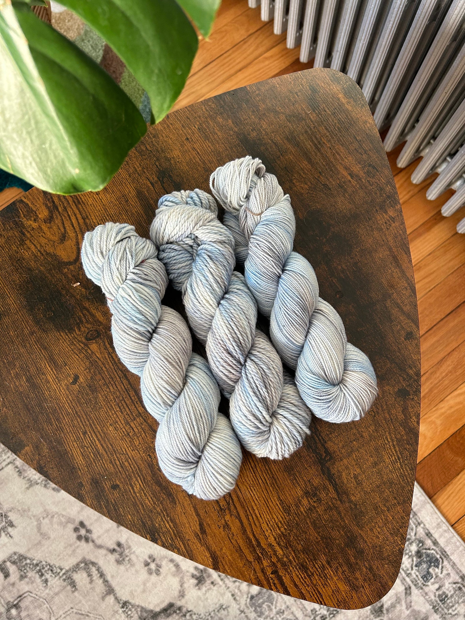 custom light blue, bright blue, soft tan, grey variegated hand dyed yarn on nylon superwash merino sock weight