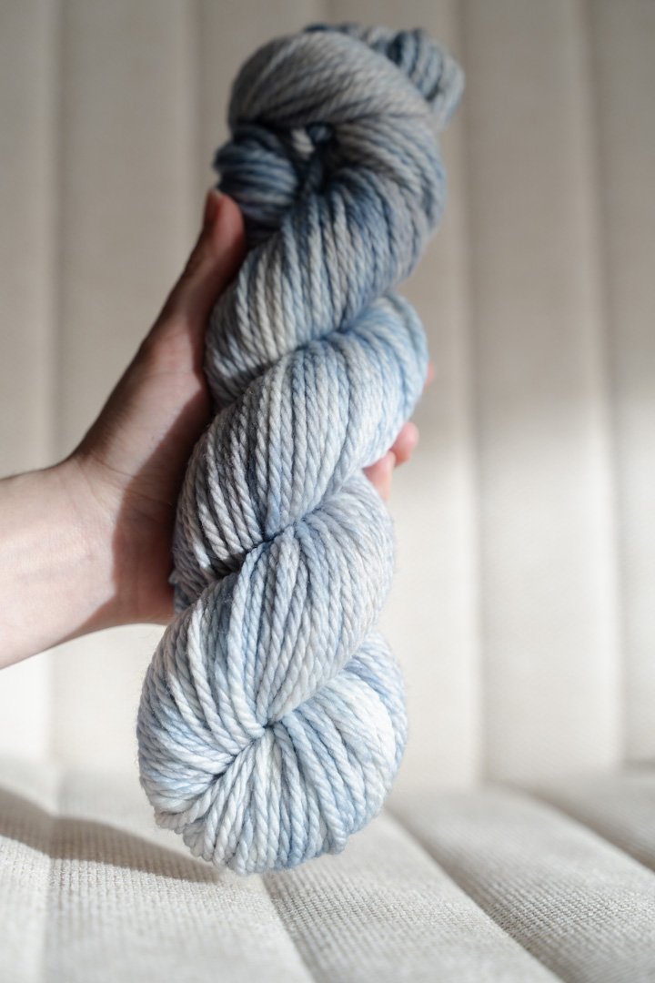 custom light blue, bright blue, soft tan, grey variegated hand dyed yarn on superwash merino chunky weight