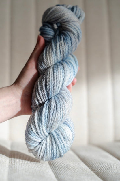 custom light blue, bright blue, soft tan, grey variegated hand dyed yarn on superwash merino chunky weight