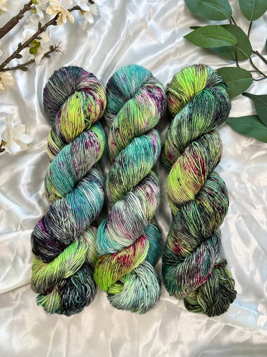 custom neon green, aqua, teal, black variegated hand dyed yarn with magenta and cherry red speckles on nylon superwash merino sock weight and linen sock