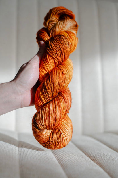 custom saffron, orange, cocoa brown, gold variegated hand dyed yarn on nylon superwash merino sock weight