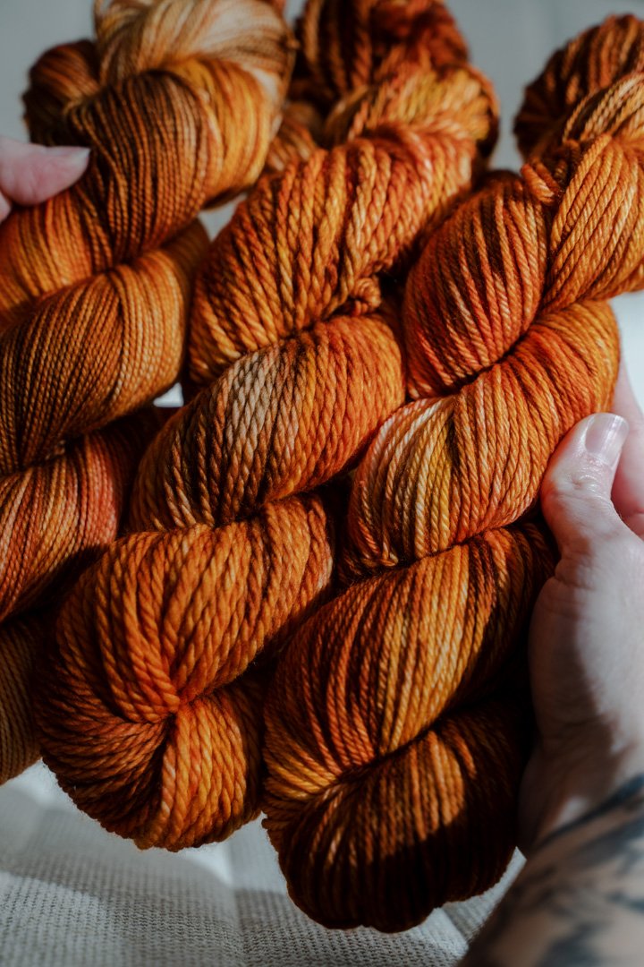 custom saffron, orange, cocoa brown, gold variegated hand dyed yarn on nylon superwash merino sock weight