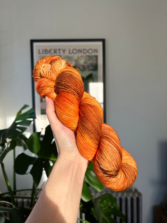custom saffron, orange, cocoa brown, gold variegated hand dyed yarn on nylon superwash merino sock weight