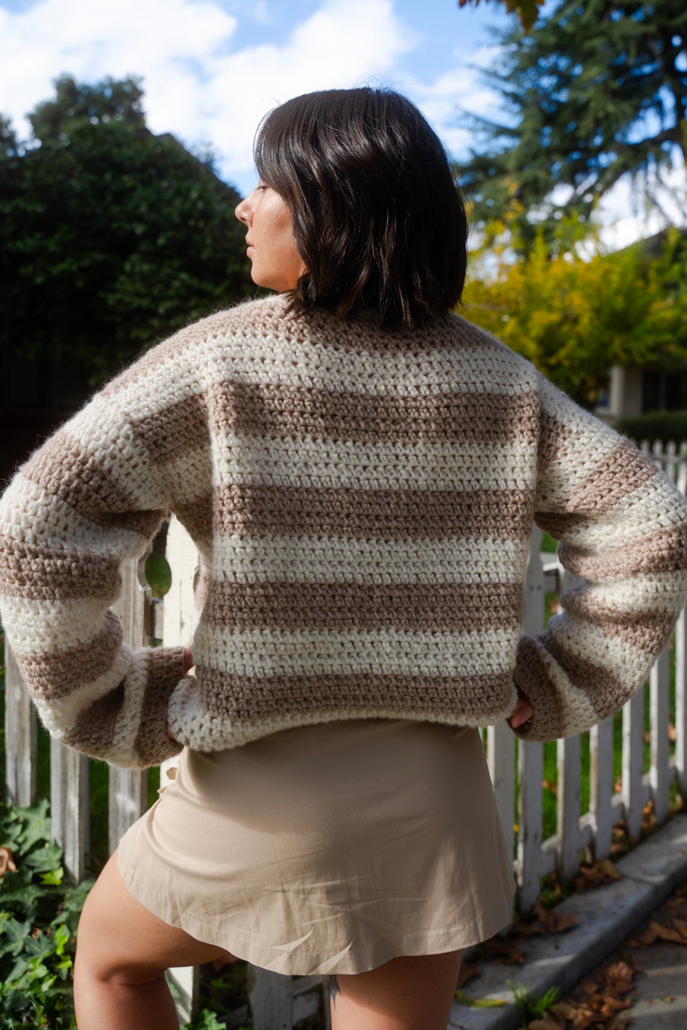 erin wearing a fluffy soft striped crochet sweater with crew neckline and tapered sleeves