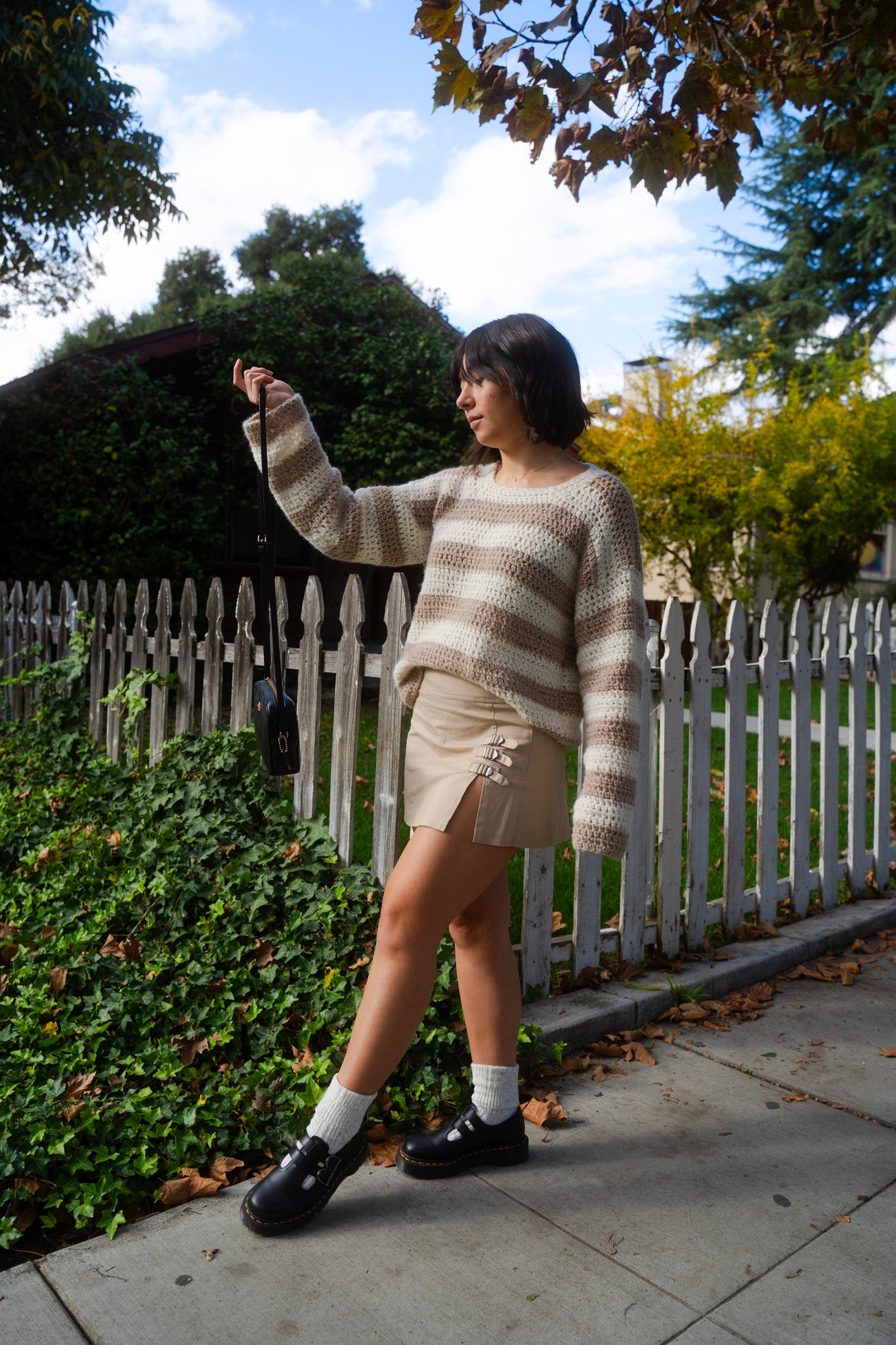 erin wearing a fluffy soft striped crochet sweater with crew neckline and tapered sleeves
