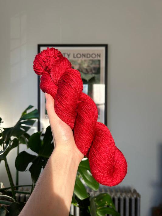 custom medium toned cherry red semisolid hand dyed yarn on nylon superwash sock yarn