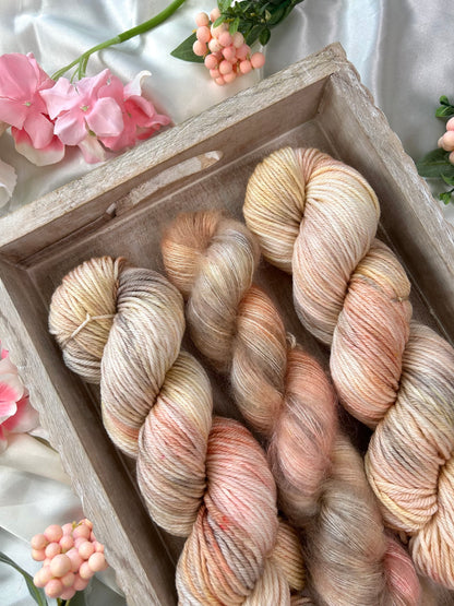 custom cream, salmon pink, light yellow variegated hand dyed yarn on superwash merino dk weight and silk mohair weight 