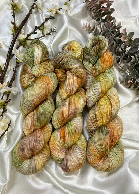 custom orange, moss green, gold, sepia brown variegated hand dyed yarn on superwash merino fingering weight
